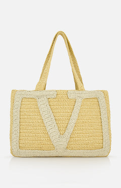 The Viva Superstar Crochet Large Tote Bag by VALENTINO GARAVANI is a woven beige bag with dual handles and a bold light V pattern—perfect as a stylish beach tote for sunny days.