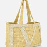 The Viva Superstar Crochet Large Tote Bag by VALENTINO GARAVANI is a beige woven rectangular tote with two handles and a large cream V design, featuring a textured, handcrafted look.