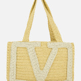 The VALENTINO GARAVANI Viva Superstar Crochet Medium Tote Bag features two handles, a large cream V design, and a natural woven texture—blending minimalist elegance with practicality for your next seaside outing.