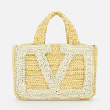 The Viva Superstar Crochet Small Tote Bag by VALENTINO GARAVANI is a yellow synthetic raffia mini tote with two short handles, a large light V pattern on the front, and a textured crochet look on a white background.