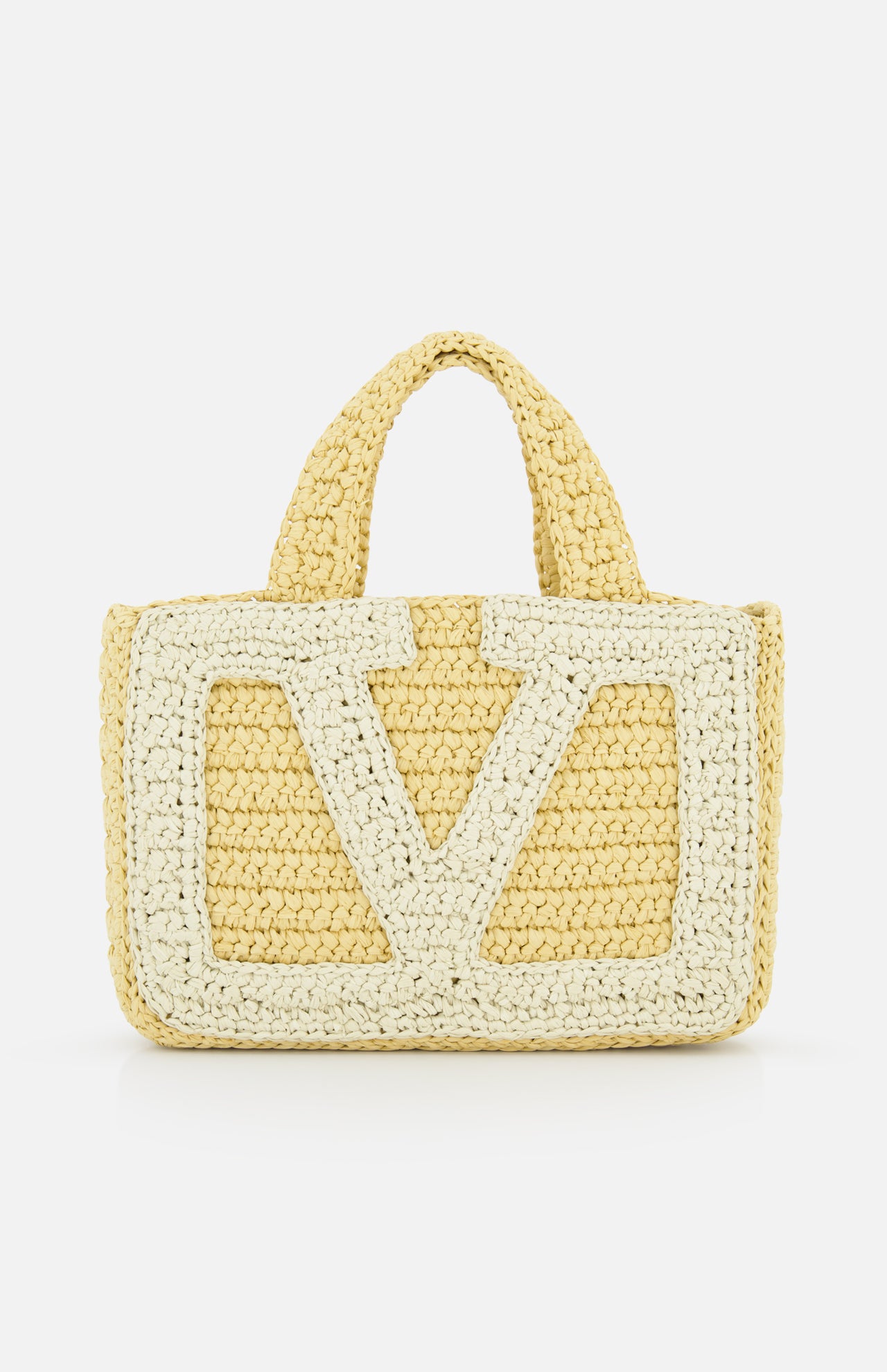 The Viva Superstar Crochet Small Tote Bag by VALENTINO GARAVANI is a yellow synthetic raffia mini tote with two short handles, a large light V pattern on the front, and a textured crochet look on a white background.