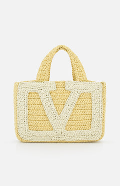 The Viva Superstar Crochet Small Tote Bag by VALENTINO GARAVANI is a yellow synthetic raffia mini tote with two short handles, a large light V pattern on the front, and a textured crochet look on a white background.