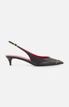 The VALENTINO GARAVANI VLogo Heartip Sling Back Heel is a black leather kitten-heel with a pointed toe, red interior, gold ankle buckle, and gold toe accent—elegantly crafted in Italy.