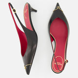 The VALENTINO GARAVANI VLogo Heartip Sling Back Heel is a black leather pointed-toe slingback with red insoles and gold trim, made in Italy, shown from above on a white background.