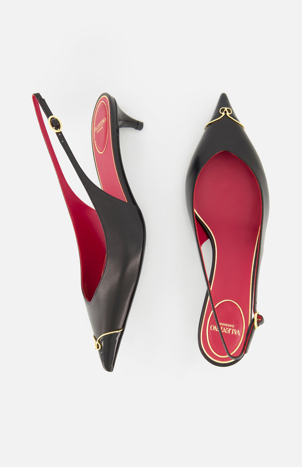 The VALENTINO GARAVANI VLogo Heartip Sling Back Heel is a black leather pointed-toe slingback with red insoles and gold trim, made in Italy, shown from above on a white background.