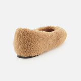 The VALENTINO GARAVANI VLogo Signature Ballerina Flat, a tan fuzzy teddy bear-style ballet flat with a black sole, is shown angled from the back on a white background.