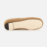 The image shows the bottom view of the VLogo Signature Ballerina Flat by VALENTINO GARAVANI, featuring a tan shearling design with a beige sole and a black heel cap, photographed against a white background.