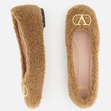 A pair of brown fuzzy VALENTINO GARAVANI VLogo Signature Ballerina Flats featuring gold VLogo detail accents on the toes, displayed from above on a white background.