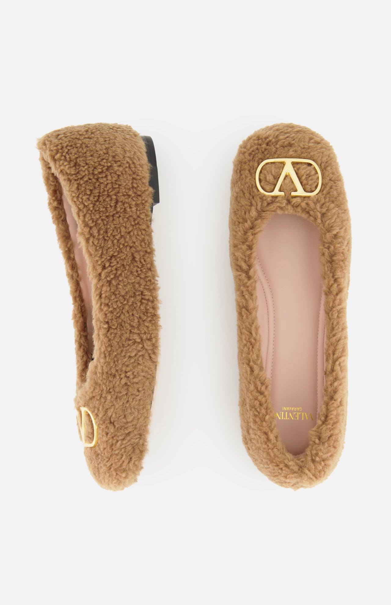 A pair of brown fuzzy VALENTINO GARAVANI VLogo Signature Ballerina Flats featuring gold VLogo detail accents on the toes, displayed from above on a white background.