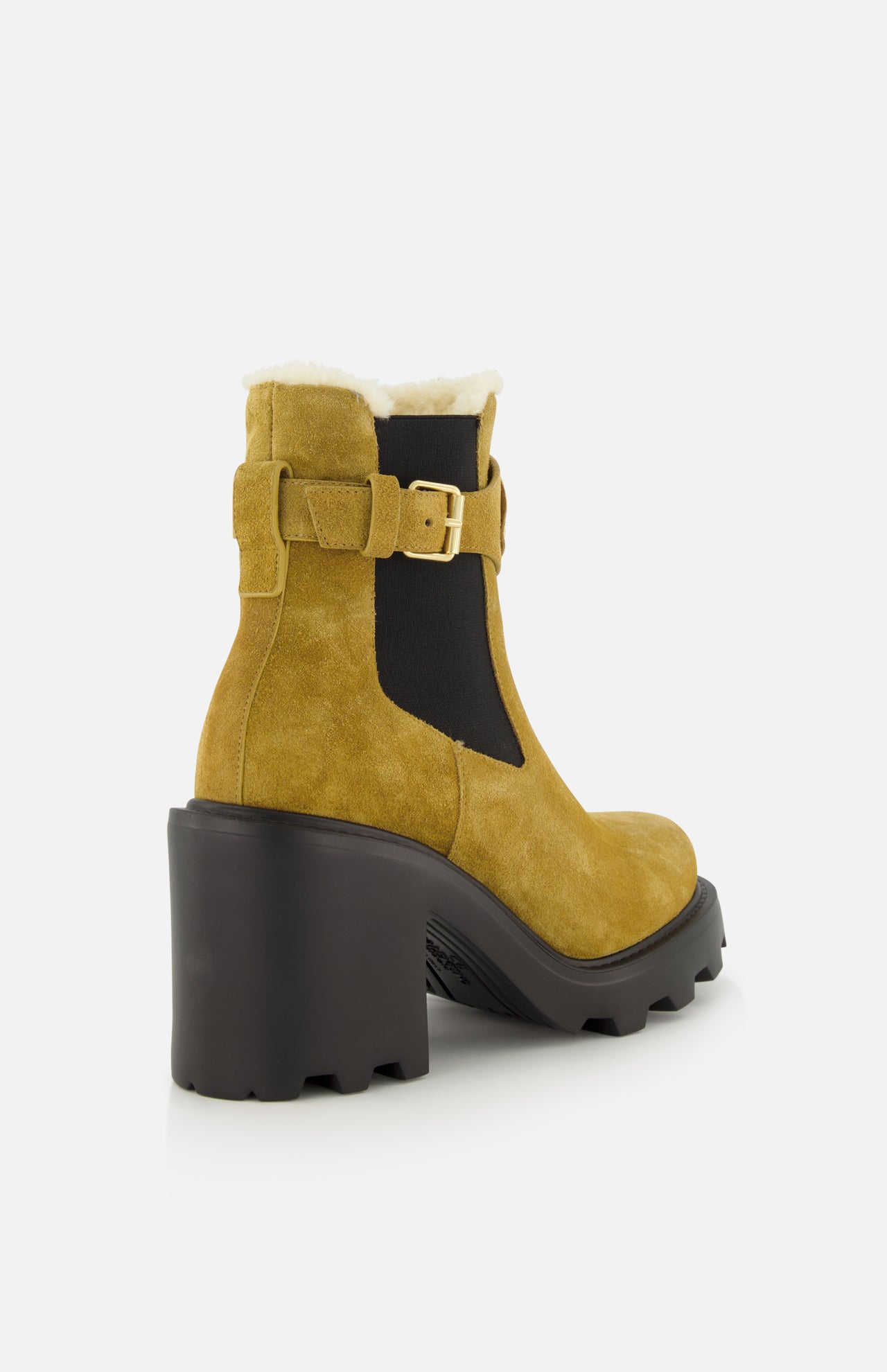 The VALENTINO GARAVANI VLogo Signature Beatle Boot is a pair of beige Chelsea boots crafted from tan suede, featuring a chunky black heel and sole, black elastic side panels, sleek gold buckle detail inspired by VLogo hardware, and a plush white fleece lining—all showcased against a white background.
