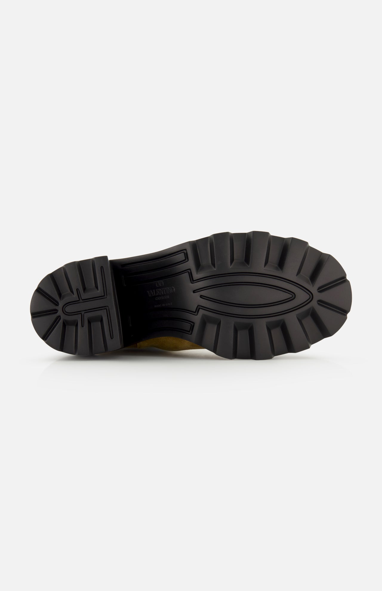 The image shows the black, textured rubber sole of the VALENTINO GARAVANI VLogo Signature Beatle Boot, viewed from the bottom against a plain white background. The sole, designed for these beige Chelsea boots, features deep, rugged treads for enhanced traction.
