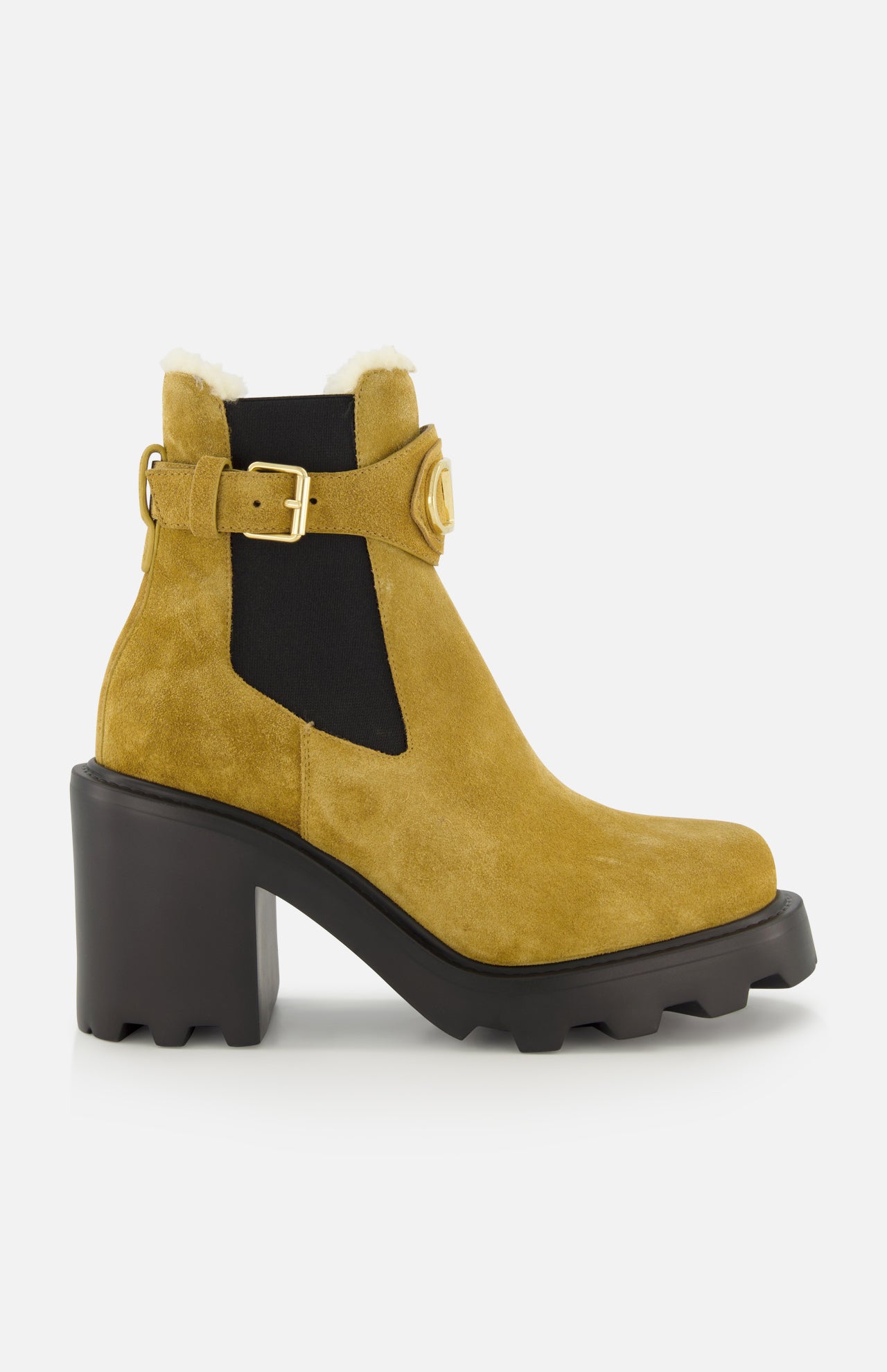Introducing the VALENTINO GARAVANI VLogo Signature Beatle Boot: a mustard yellow suede ankle boot featuring a chunky black heel, rugged sole, side cutout, black elastic panel inspired by classic Chelsea boots in beige, gold buckle detail, and white shearling trim at the top.