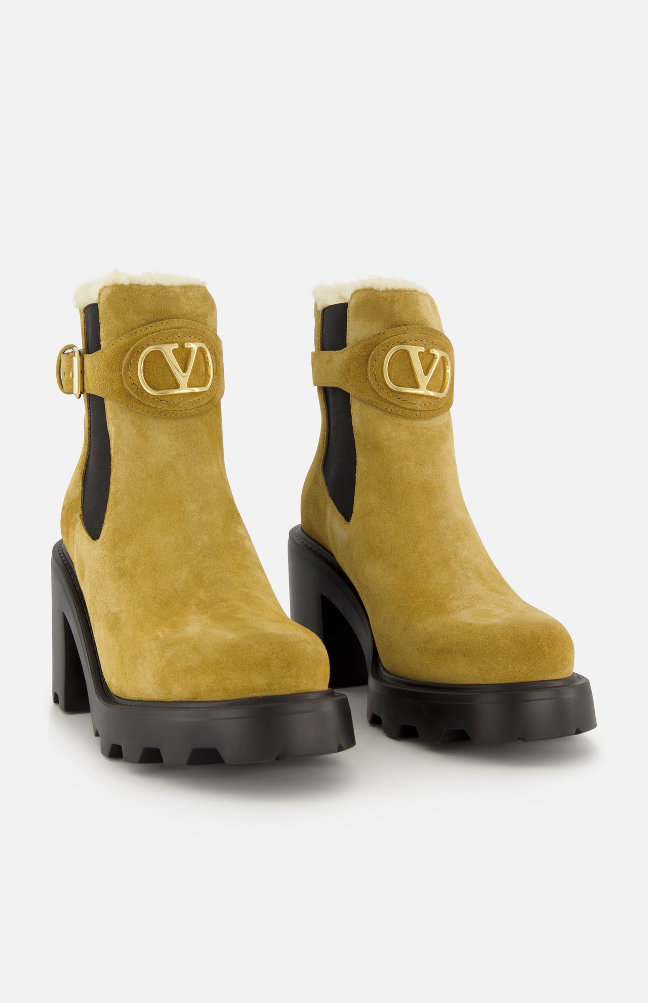 Step up your style with the VALENTINO GARAVANI VLogo Signature Beatle Boot: a pair of mustard yellow suede ankle boots featuring chunky black heels and soles, gold buckles, black side panels, and striking gold VLogo hardware on the front—offering a bold twist on classic style.