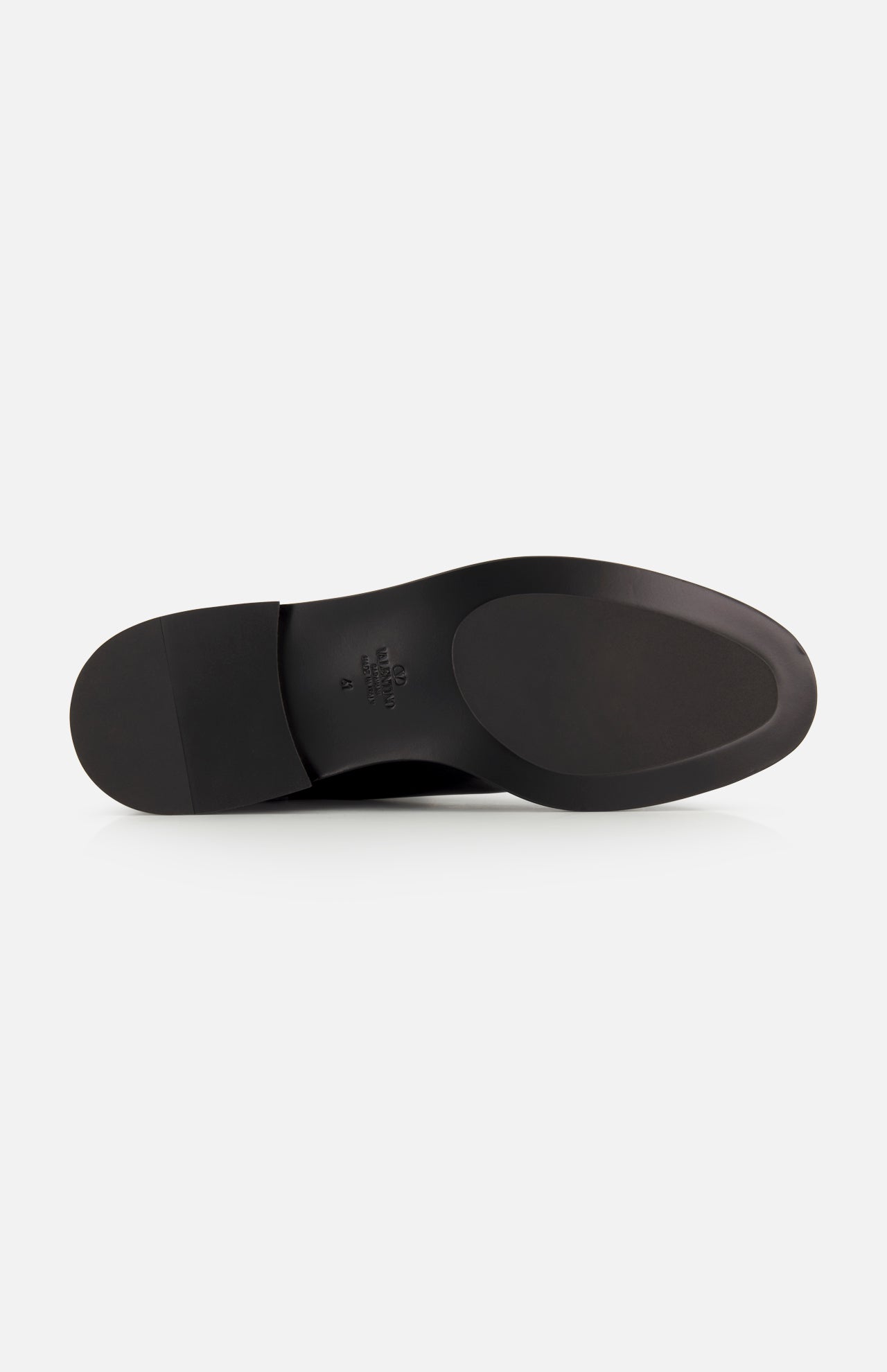 The image shows the bottom of the VALENTINO GARAVANI VLogo Signature Boot, featuring a smooth black leather sole and a slightly raised heel, photographed against a plain white background.