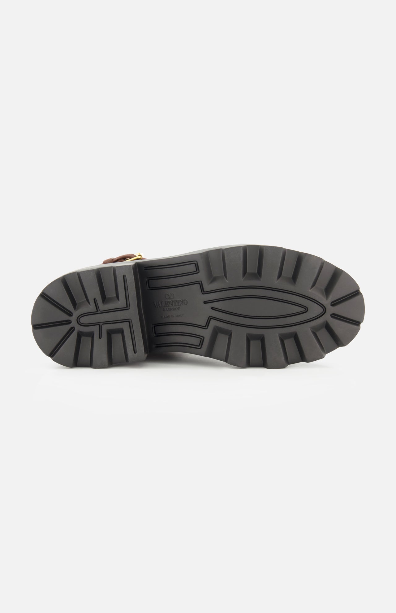 The image shows the black rubber sole of the VALENTINO GARAVANI VLogo Signature Sheepskin Bootie, featuring deep tread patterns and photographed from the bottom against a plain white background.