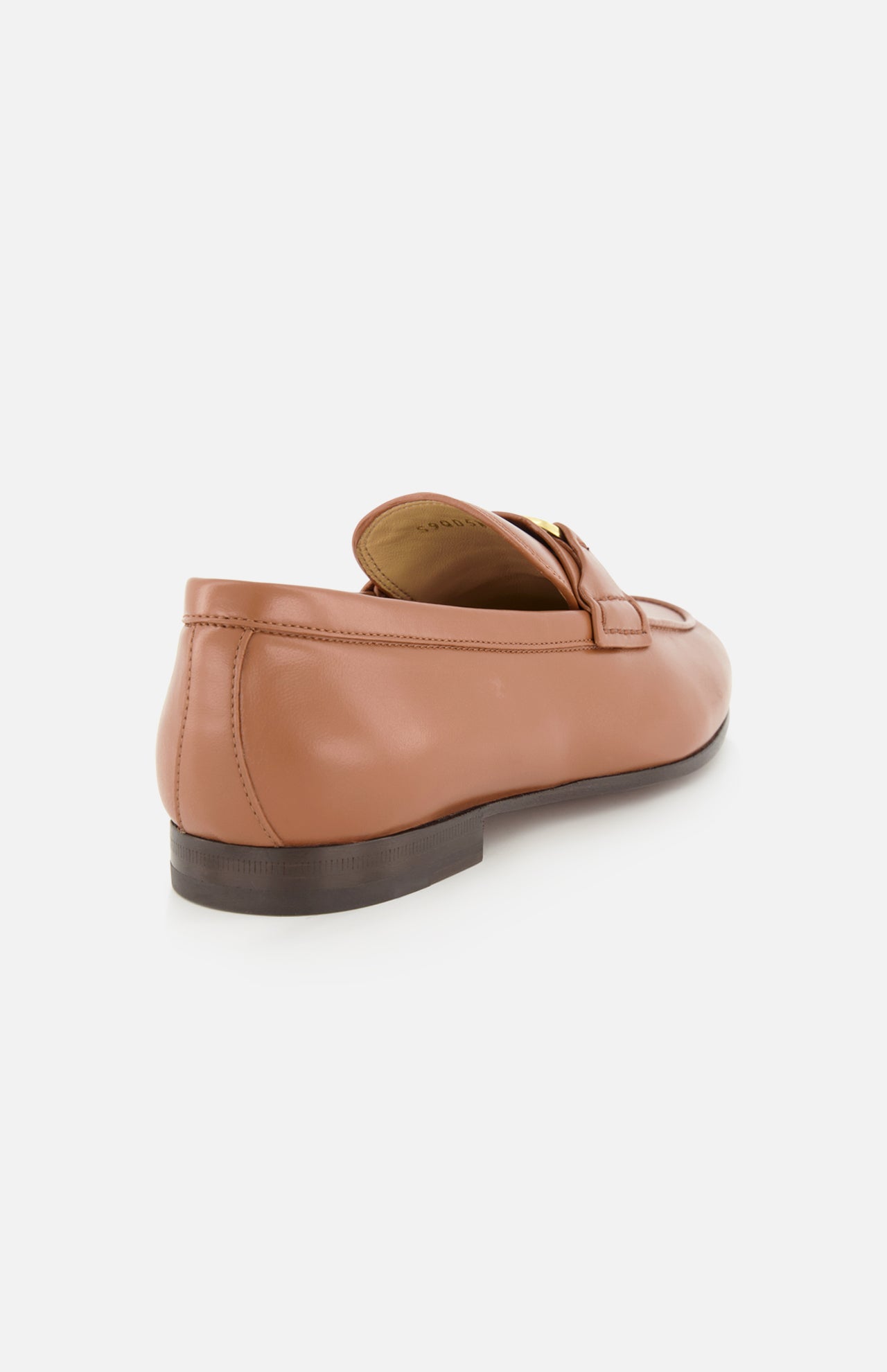 The VALENTINO GARAVANI VLogo Signature Loafer is shown at a back side angle against a white background, highlighting its light brown leather construction with an almond-shaped toe, low dark sole, and distinctive gold buckle detail on the upper front.
