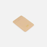 Beige leather Valentino Garavani VLogo Signature Magnetic Card Holder with a gold-tone logo emblem on the front and multiple card slots.
