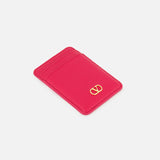 The VALENTINO GARAVANI VLogo Signature Magnetic Card Holder is a slim, vibrant pink leather accessory featuring two card slots and a small gold VLogo emblem in the bottom right corner, shown against a plain white background.