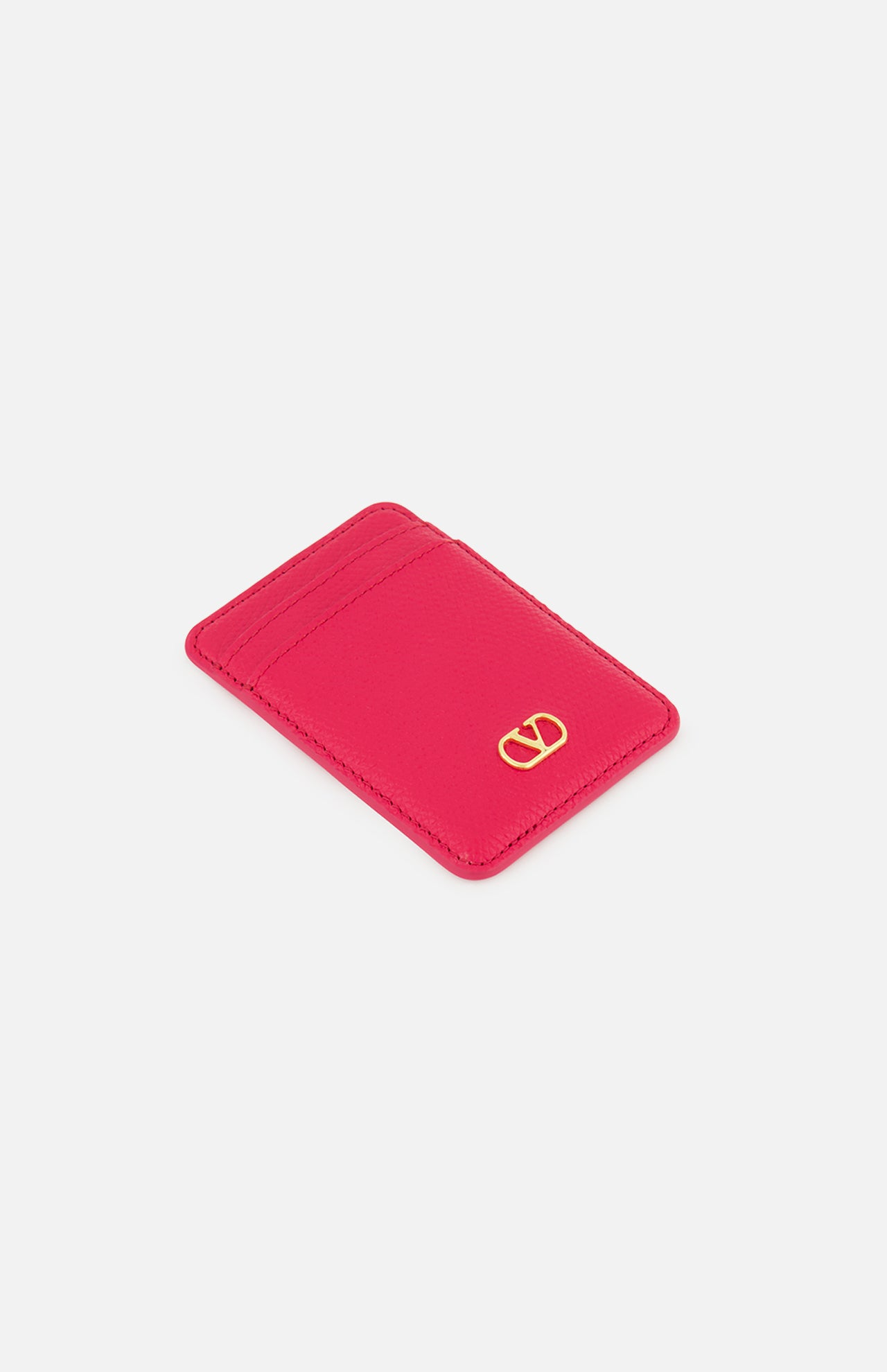 The VALENTINO GARAVANI VLogo Signature Magnetic Card Holder is a slim, vibrant pink leather accessory featuring two card slots and a small gold VLogo emblem in the bottom right corner, shown against a plain white background.