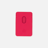 Displayed on a plain white background, the VALENTINO GARAVANI VLogo Signature Magnetic Card Holder features a vibrant pink leather design with an oval cutout in the center and embossed Valentino branding at the bottom.