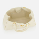 The VALENTINO GARAVANI VLogo Signature Mini Bag is an ivory bowling bag with gold hardware, an open top view revealing a roomy interior, a small inner pocket, and two handles.