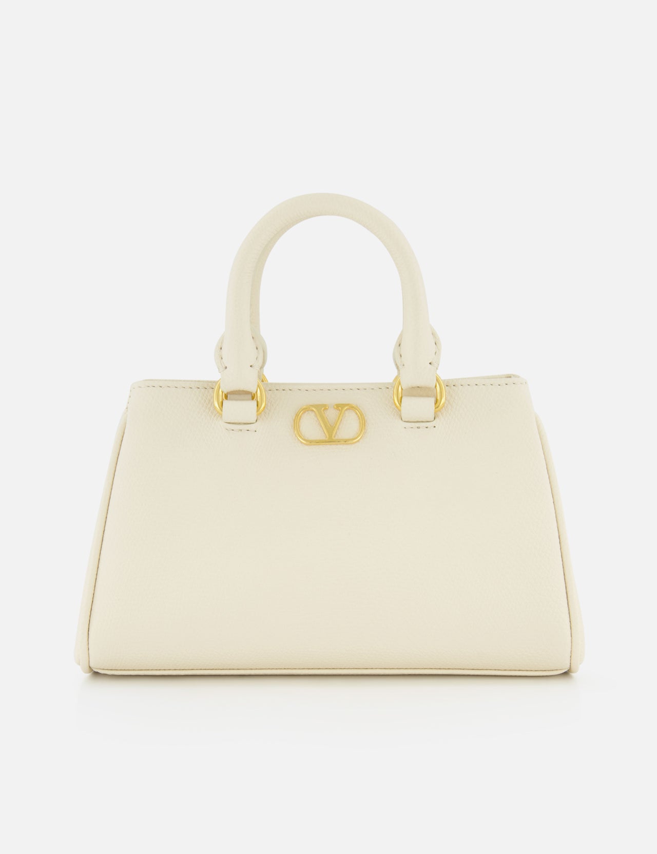 The VALENTINO GARAVANI VLogo Signature Mini Bag is an ivory bowling bag with two short handles, gold hardware, and a bold gold V logo on the front, shown against a plain white background.
