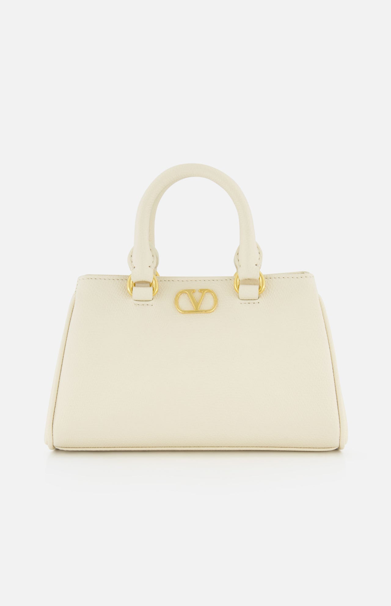 The VALENTINO GARAVANI VLogo Signature Mini Bag is an ivory bowling bag with two short handles, gold hardware, and a bold gold V logo on the front, shown against a plain white background.