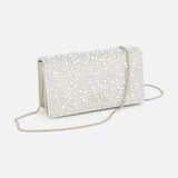 The VALENTINO GARAVANI VLogo Signature Swarovski Crystals Mini Bag is a small, elegant clutch adorned with sparkling Swarovski crystals, featuring a silver chain strap and the iconic metallic VLogo detail on the front—an exquisite accessory perfect for special occasions.