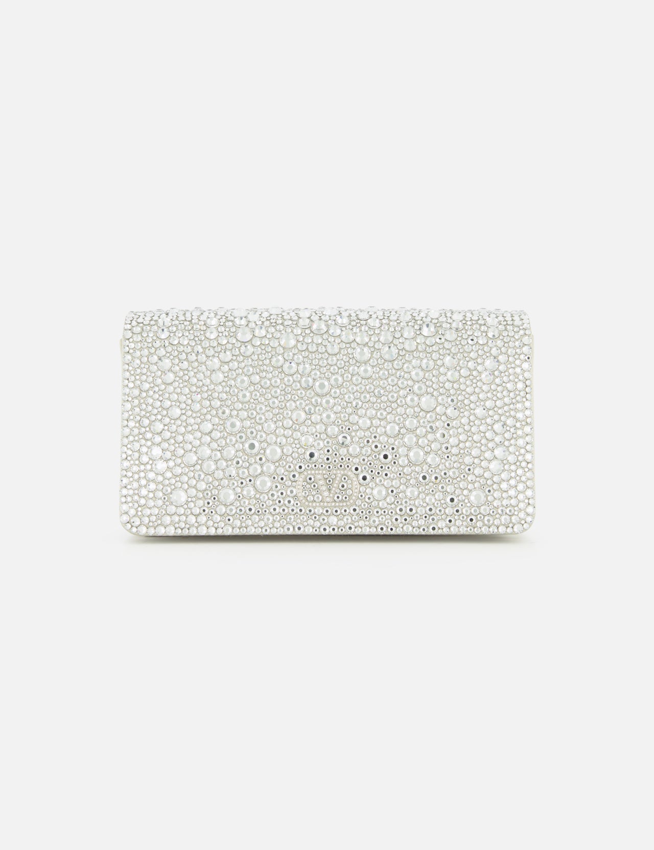 The VALENTINO GARAVANI VLogo Signature Swarovski Crystals Mini Bag exudes effortless elegance with its rectangular white silhouette, adorned in shimmering Swarovski crystals and lustrous pearls. Set against a plain white background, this exquisite silver mini bag captures the light with every detail, making it the perfect special occasion accessory.