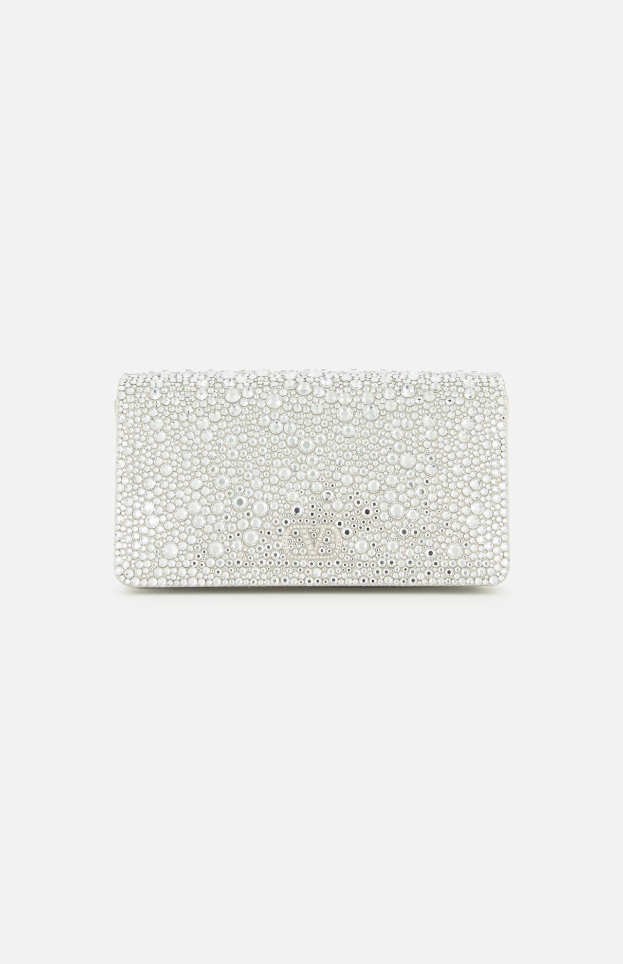 The VALENTINO GARAVANI VLogo Signature Swarovski Crystals Mini Bag exudes effortless elegance with its rectangular white silhouette, adorned in shimmering Swarovski crystals and lustrous pearls. Set against a plain white background, this exquisite silver mini bag captures the light with every detail, making it the perfect special occasion accessory.