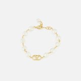 The VALENTINO GARAVANI VLogo Signature Pearl Bracelet features gold-tone links, alternating white pearls and glass beads, a central gold VLogo, and an adjustable clasp.