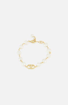 The VALENTINO GARAVANI VLogo Signature Pearl Bracelet features gold-tone links, alternating white pearls and glass beads, a central gold VLogo, and an adjustable clasp.
