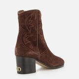 A pair of VALENTINO GARAVANI Zimmy Western Booties in dark brown suede, featuring decorative stitching, a chunky black heel, and a gold V logo on the heel, photographed against a white background.