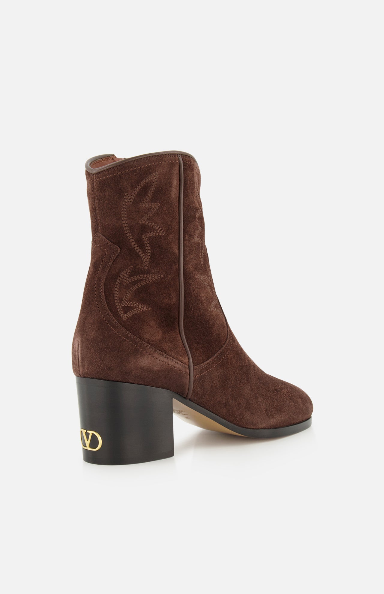 A pair of VALENTINO GARAVANI Zimmy Western Booties in dark brown suede, featuring decorative stitching, a chunky black heel, and a gold V logo on the heel, photographed against a white background.