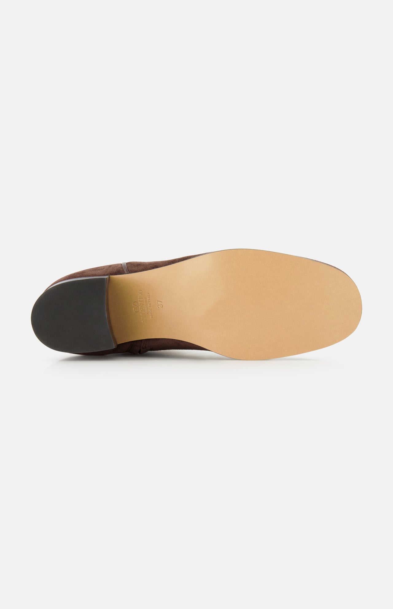 A close-up view of the sole of the VALENTINO GARAVANI Zimmy Western Bootie showcases a smooth tan leather bottom and a black heel, evocative of classic western boots, photographed against a plain white background.