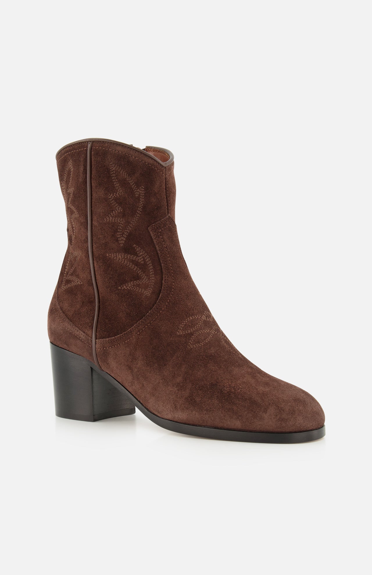 The Zimmy Western Bootie by VALENTINO GARAVANI showcases dark brown suede with a medium block heel, subtle decorative stitching, and a rounded toe reminiscent of classic western boots, presented against a white background.