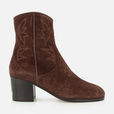 The Zimmy Western Bootie by VALENTINO GARAVANI is a brown suede ankle boot featuring western-inspired stitching, a rounded toe, and a chunky mid-height heel. Displayed in side profile against a white background, these suede booties effortlessly blend classic style with modern elegance.