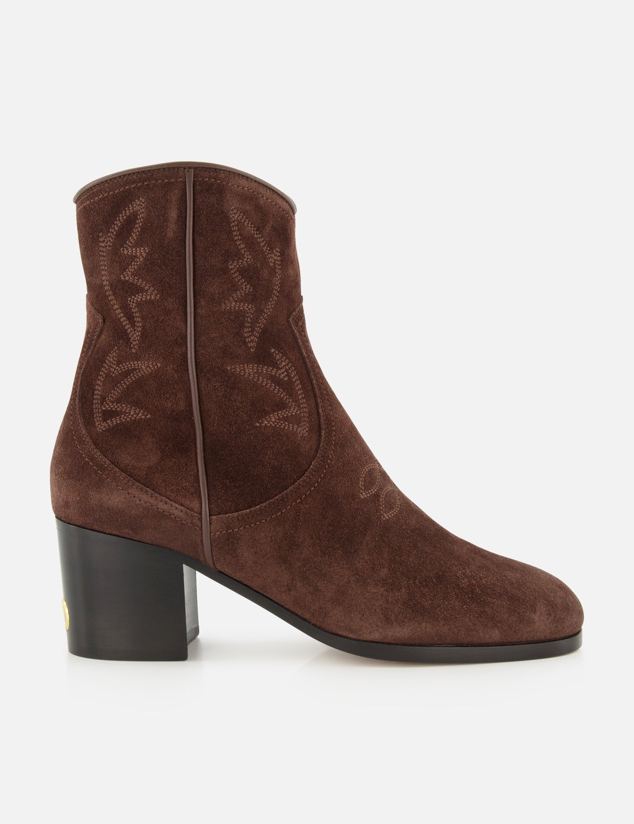 The Zimmy Western Bootie by VALENTINO GARAVANI is a brown suede ankle boot featuring western-inspired stitching, a rounded toe, and a chunky mid-height heel. Displayed in side profile against a white background, these suede booties effortlessly blend classic style with modern elegance.