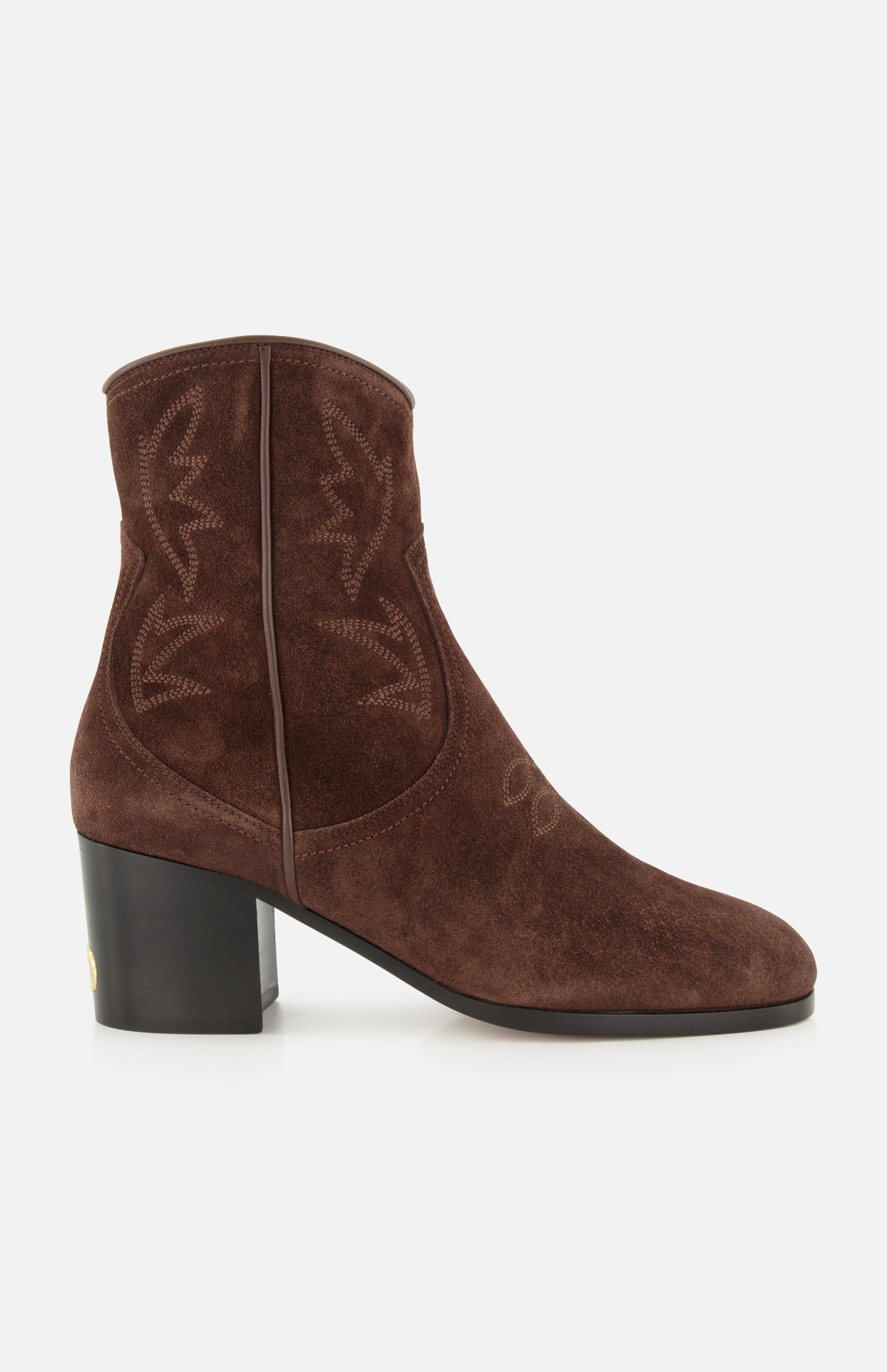 The Zimmy Western Bootie by VALENTINO GARAVANI is a brown suede ankle boot featuring western-inspired stitching, a rounded toe, and a chunky mid-height heel. Displayed in side profile against a white background, these suede booties effortlessly blend classic style with modern elegance.