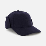 The Legacy Structured Merino Wool Earflap Hat by VARSITY HEADWEAR is a dark navy cap featuring fold-down ear flaps and an adjustable back strap, displayed at an angle on a light gray background.