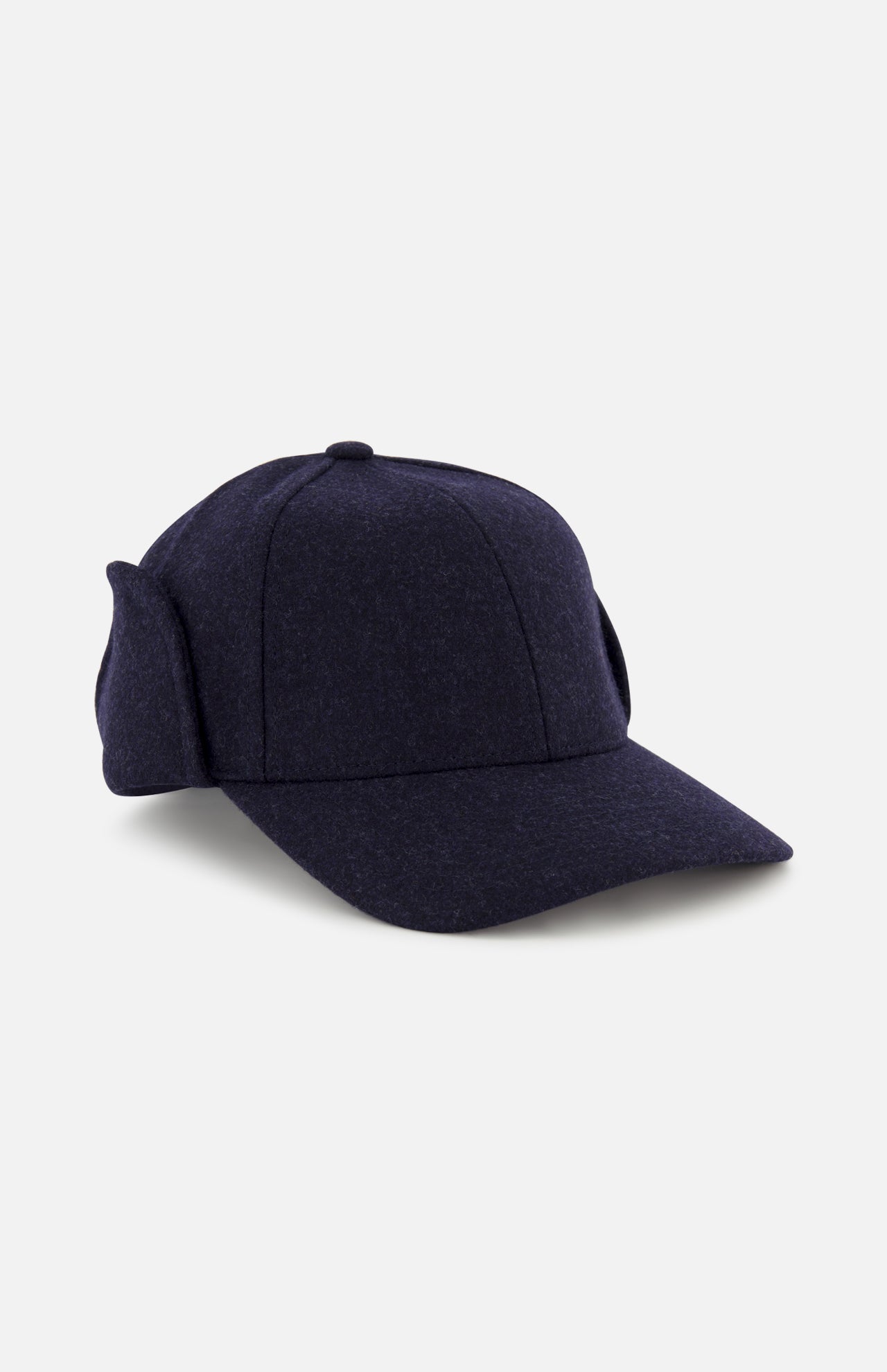 The Legacy Structured Merino Wool Earflap Hat by VARSITY HEADWEAR is a dark navy cap featuring fold-down ear flaps and an adjustable back strap, displayed at an angle on a light gray background.