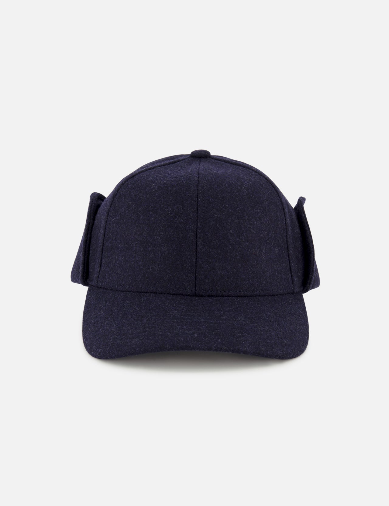 The Legacy Structured Merino Wool Earflap Hat by VARSITY HEADWEAR is shown from the front, featuring dark blue wool, side earflaps, and an adjustable back strap. The cap is photographed against a plain light gray background.