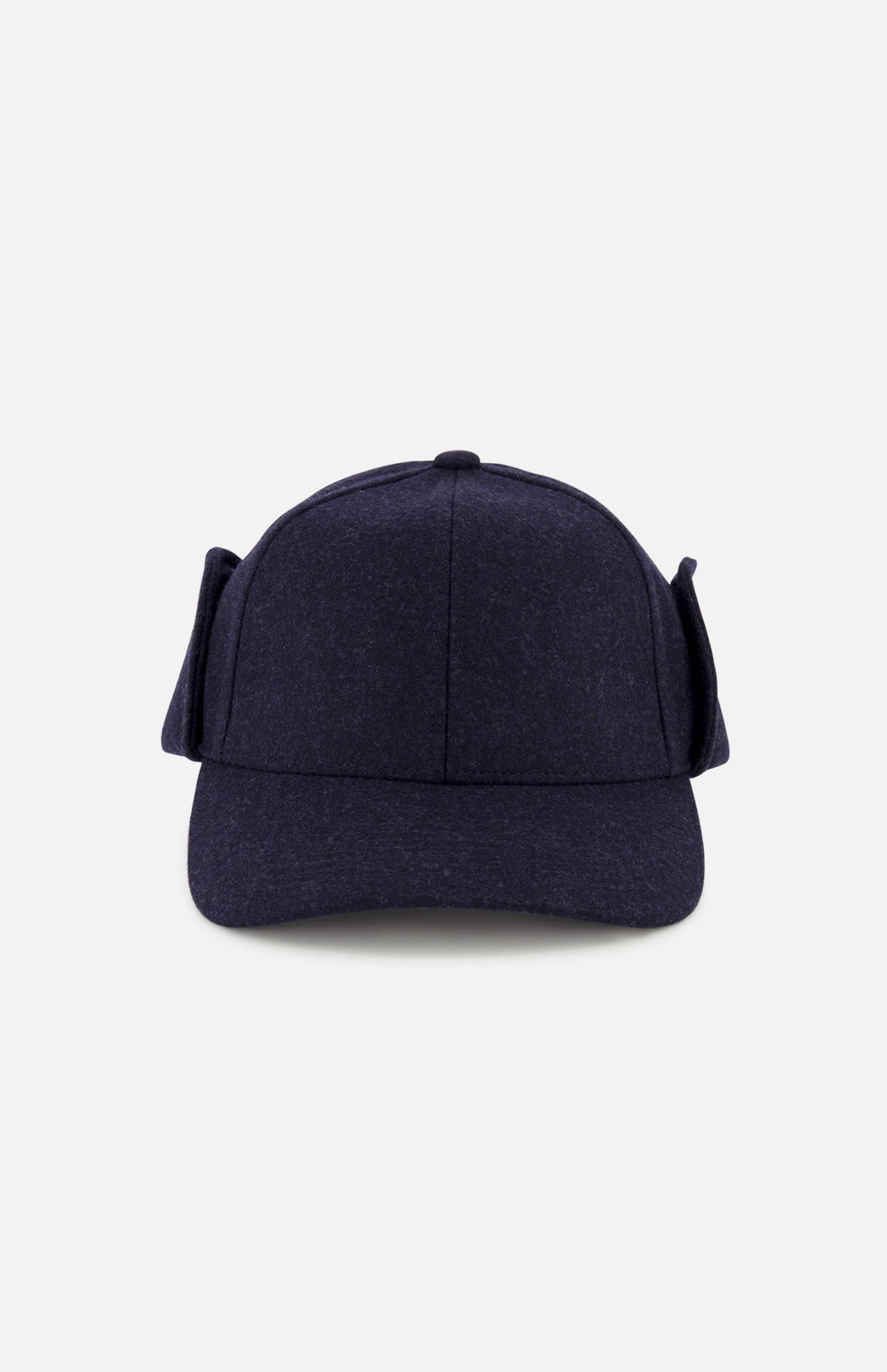 The Legacy Structured Merino Wool Earflap Hat by VARSITY HEADWEAR is shown from the front, featuring dark blue wool, side earflaps, and an adjustable back strap. The cap is photographed against a plain light gray background.