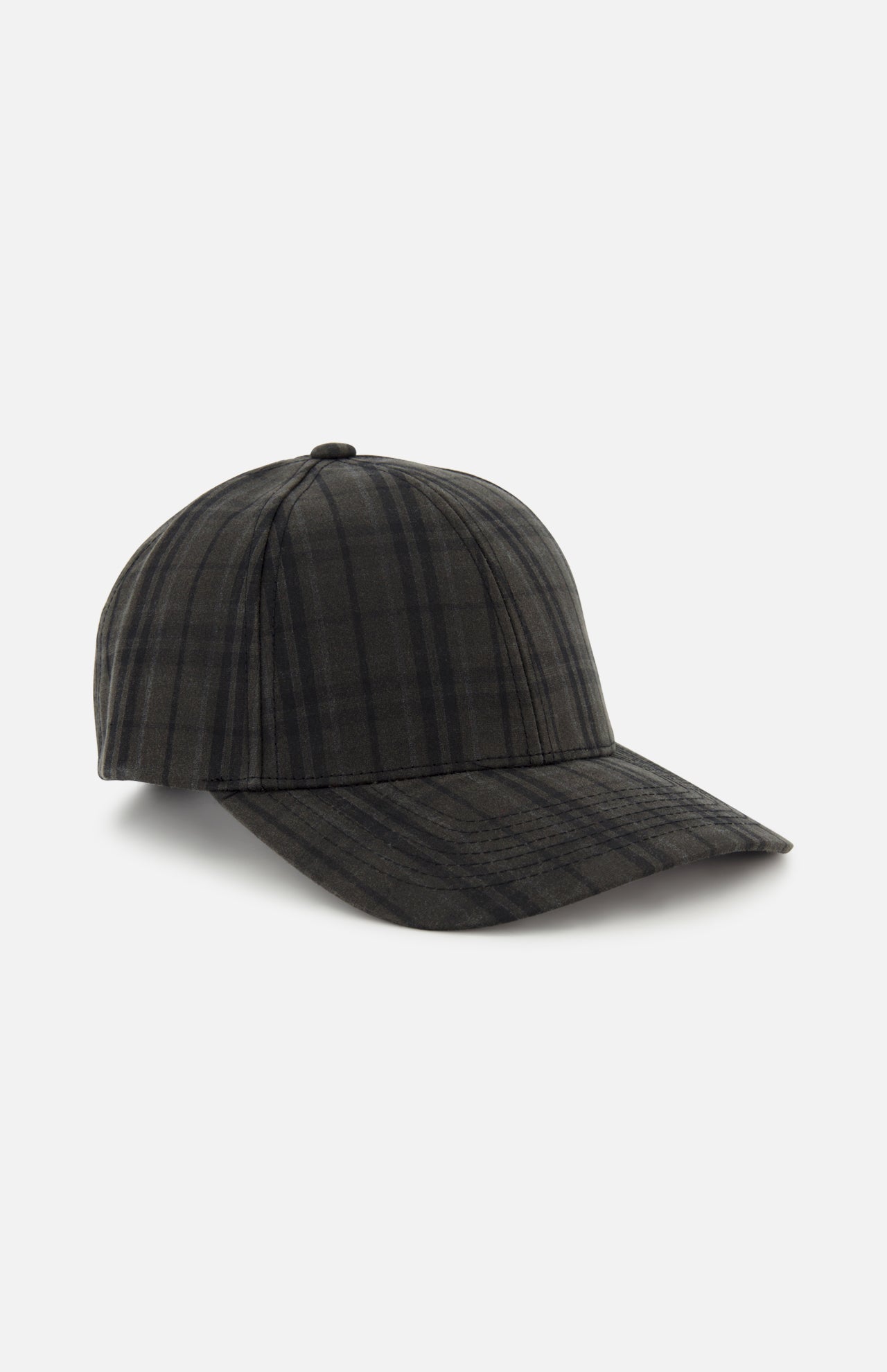 The Legacy Structured Oilskin Highland Hat by VARSITY HEADWEAR features a dark tartan plaid pattern, a curved brim, and an adjustable back strap, and is displayed against a plain white background.
