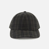 A front view of the Legacy Structured Oilskin Highland Hat by VARSITY HEADWEAR, showcasing its black and gray tartan design, curved brim, and adjustable back strap, displayed against a plain white background.
