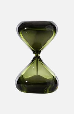 The Clessidra Sommersa Hour Glass by VENINI is a green Murano glass piece with a modern, sleek design, smooth curves, and a clear waist, photographed on a white background—a striking example of Italian decor.