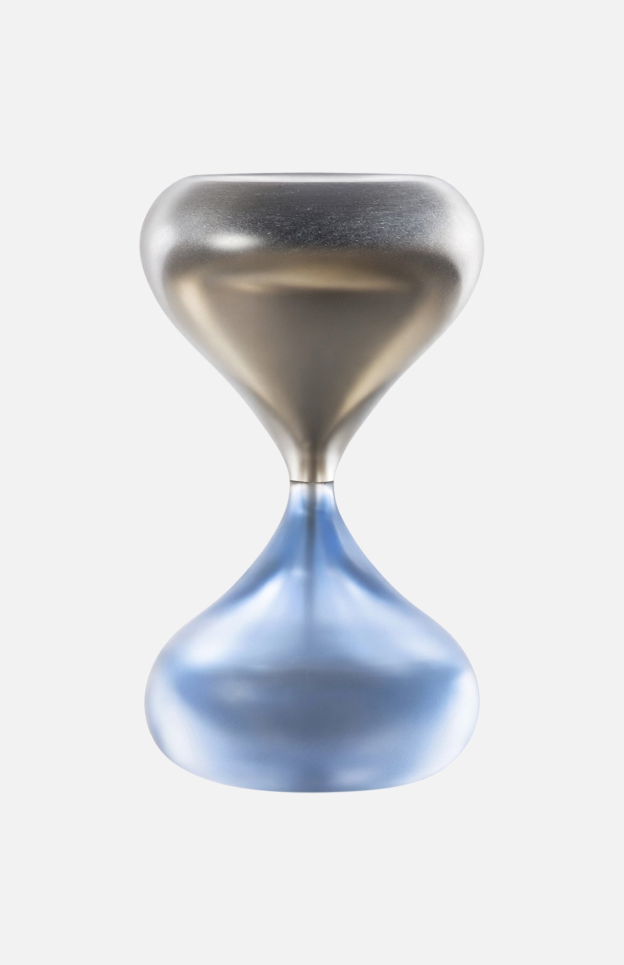 The Clessidra Sommersa Hour Glass by VENINI features a modern metallic Murano glass design with a smooth, reflective surface—silver on top and blue-tinted below. The empty hourglass is shown against a plain white background.