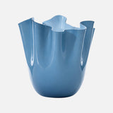 The VENINI Fazzoletto Opalino Vase is a modern sky blue Murano glass piece with an uneven, flower-like wavy rim, shown on a plain white background.