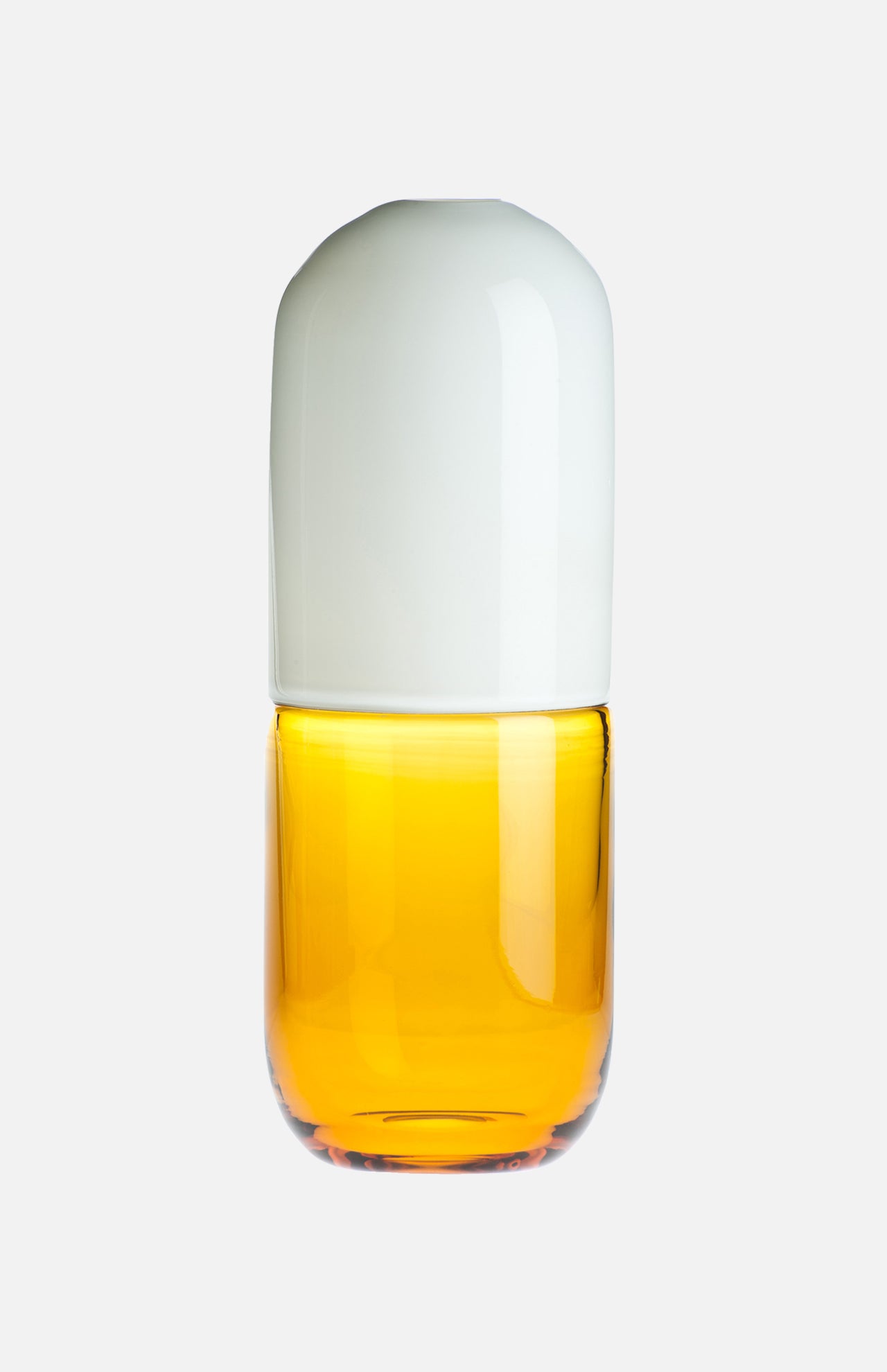 The VENINI Happy Pill Oxytocin Decor features a glass container with a white, rounded cap and transparent amber-yellow base, inspired by Murano glass artistry, shown against a plain white background.