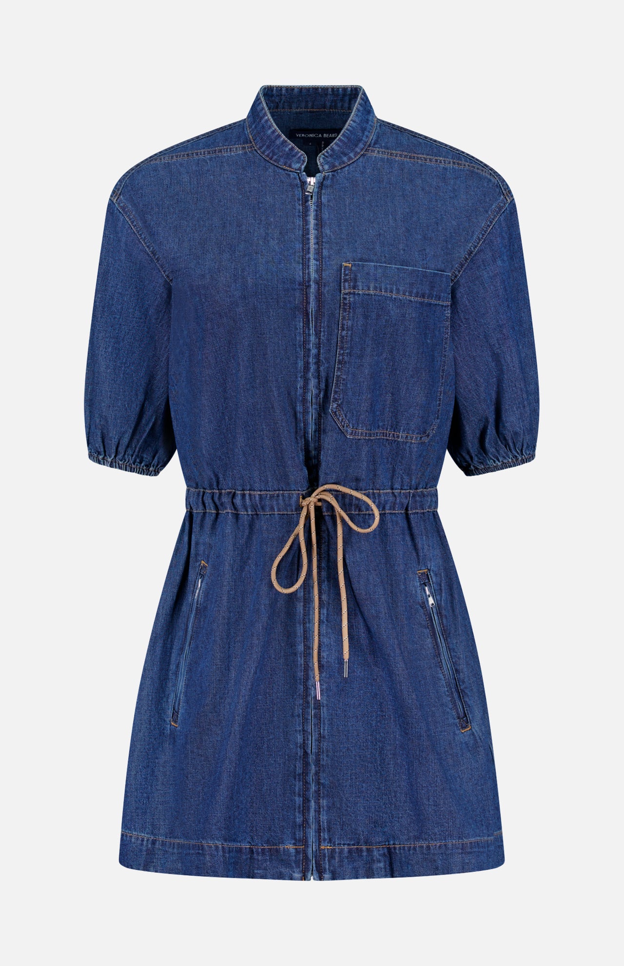 The Akerman Denim Mini Dress by VERONICA BEARD is shown against a plain white background, featuring a zip front, short sleeves, knee-length cut, drawstring waist, chest pocket, and two zippered side pockets.